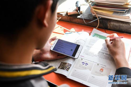  3月10日，內(nèi)蒙古準(zhǔn)格爾旗龍口鎮(zhèn)紅樹梁村的初一學(xué)生劉進(jìn)才在家中上網(wǎng)課。 新華社記者 劉磊 攝